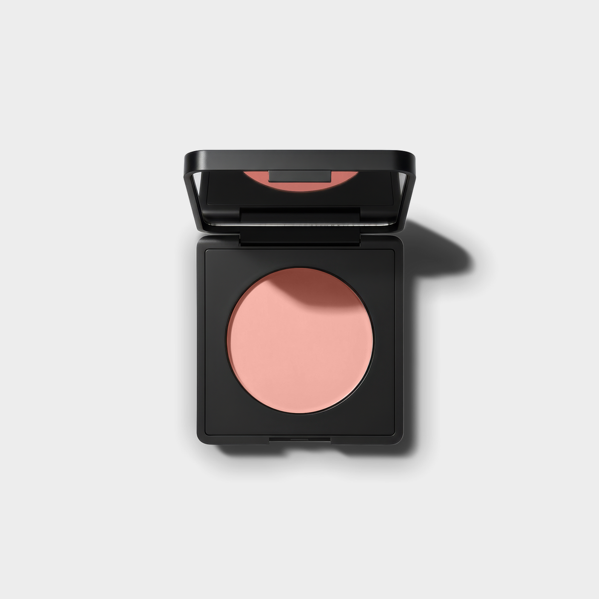 Luminance Milano Under-Eye Brightener compact, open, on a grey background