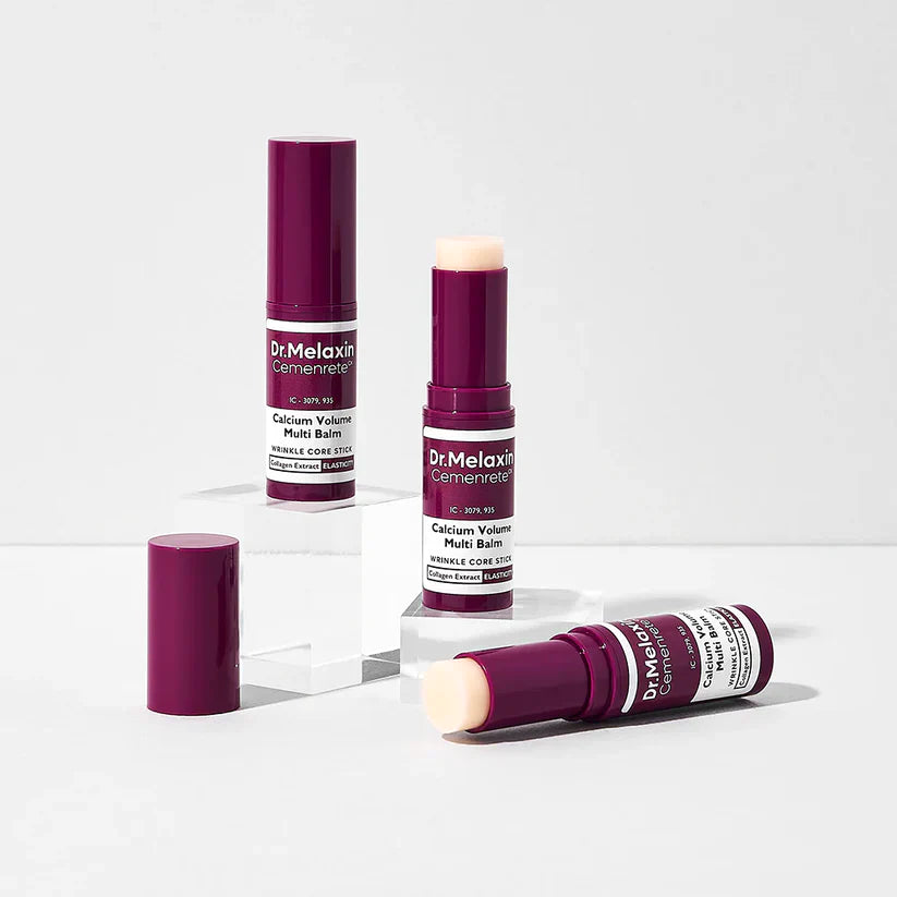 Two Dr. Melaxin Multi-Balm sticks on a grey background